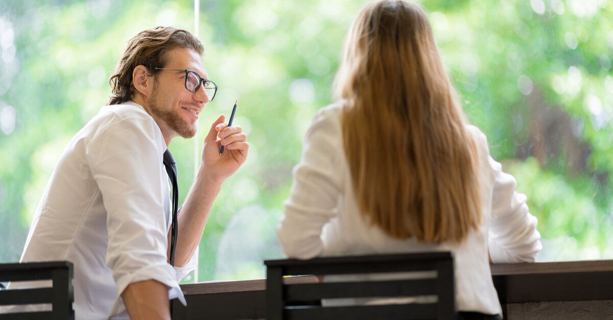 man talking to woman in meeting